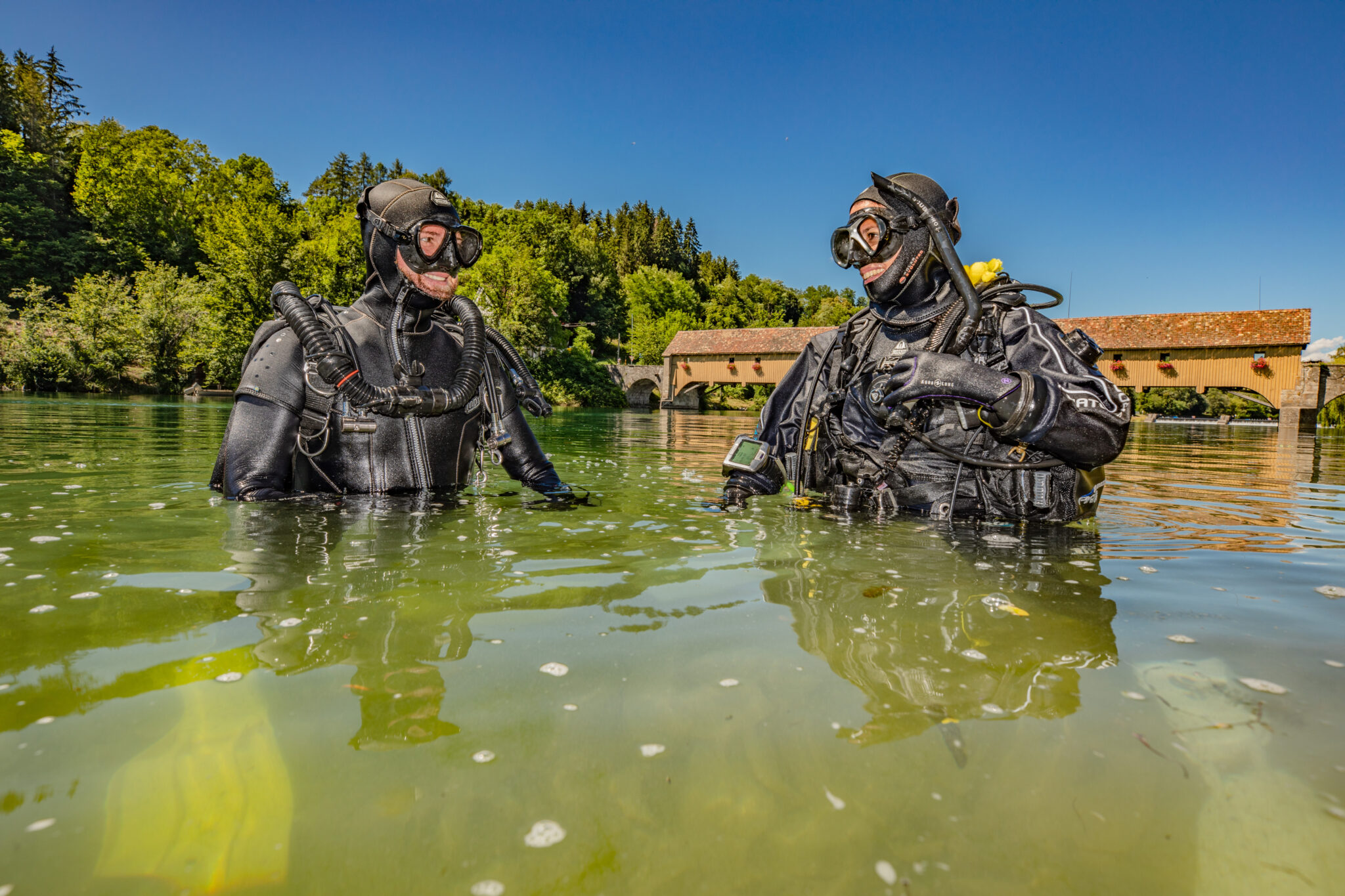 two divers smile at each other before a dive in Germany