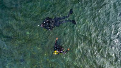 two divers learn to dive at home. This is the two divers in the water shot from a drone above them