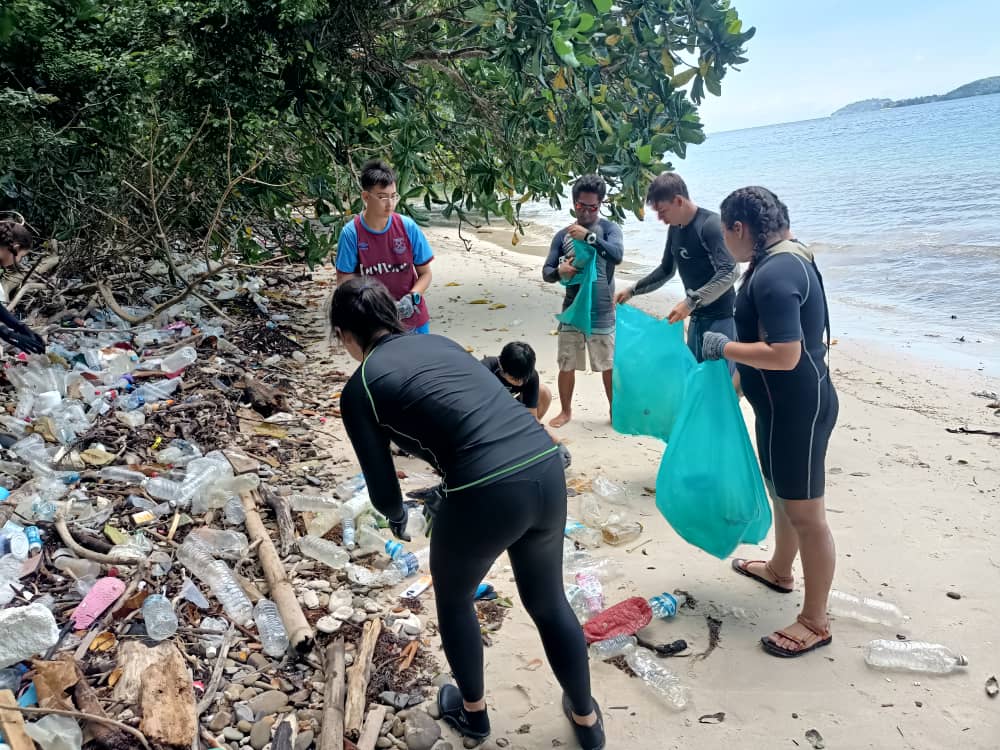 local volunteers taking part in a beach cleanup dive with padi eco center