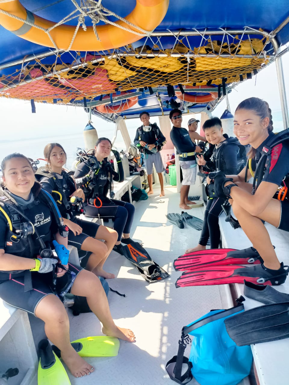 divers sat on a boat dive with padi eco center