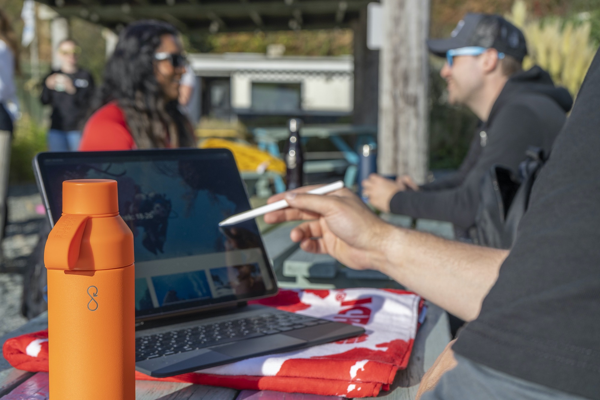 A scuba diving instructor and PADI Professional using good communication skills to teach and debrief a student after a lesson