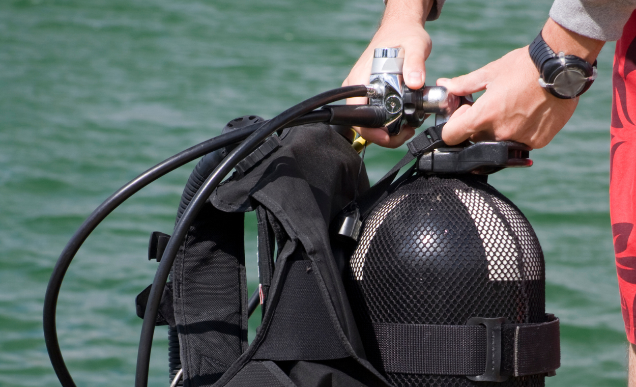 Diver getting scuba gear ready.