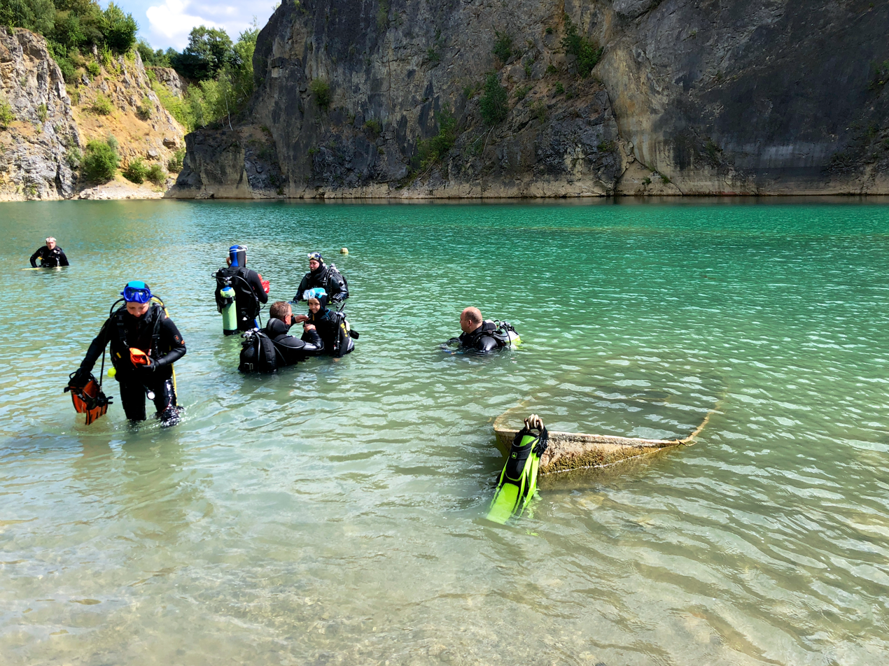 Divers entering the water in a quarry in Belgium 