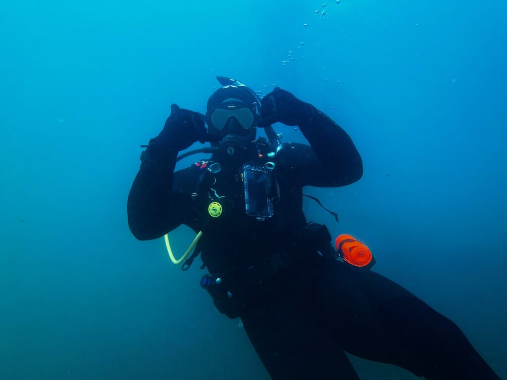 A diver holds both hands up in celebration.