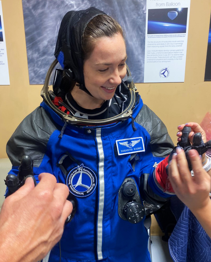 Samantha (Sami) Raines in a spacesuit