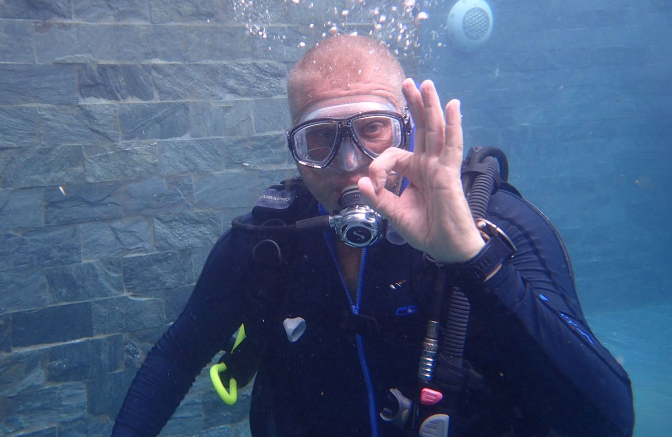 becoming a padi professional diver giving ok sign