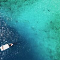 Aerial view of Scuba diving boat in the ocean at famous dive site for tiger shark in Fuvahmulah island, South Maldives. Marine Tourism and Nautical vessel industry