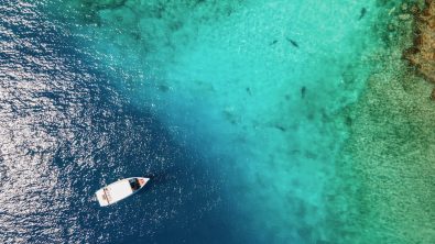 Aerial view of Scuba diving boat in the ocean at famous dive site for tiger shark in Fuvahmulah island, South Maldives. Marine Tourism and Nautical vessel industry