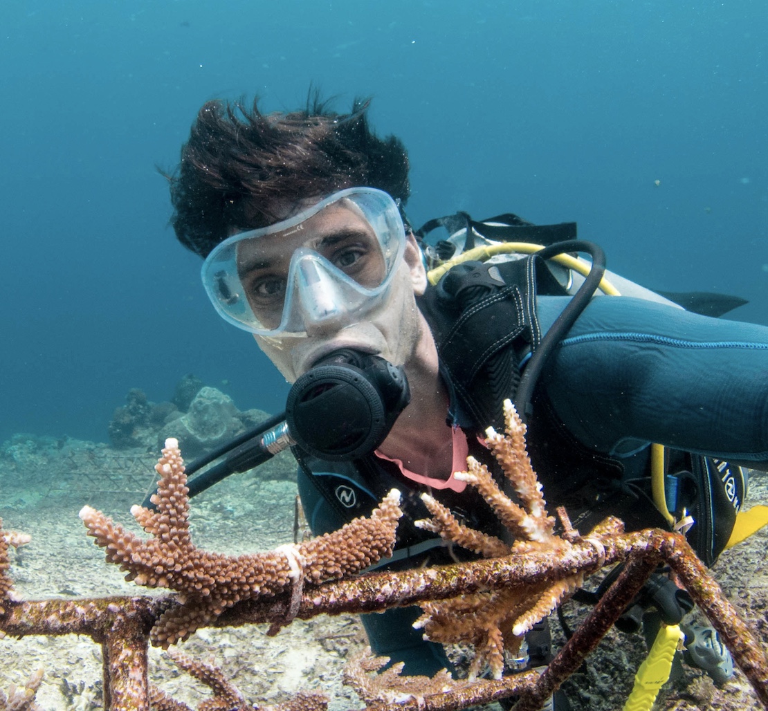 Andrew Taylor Ocean Torchbearer diving in front of his coral restoration structure