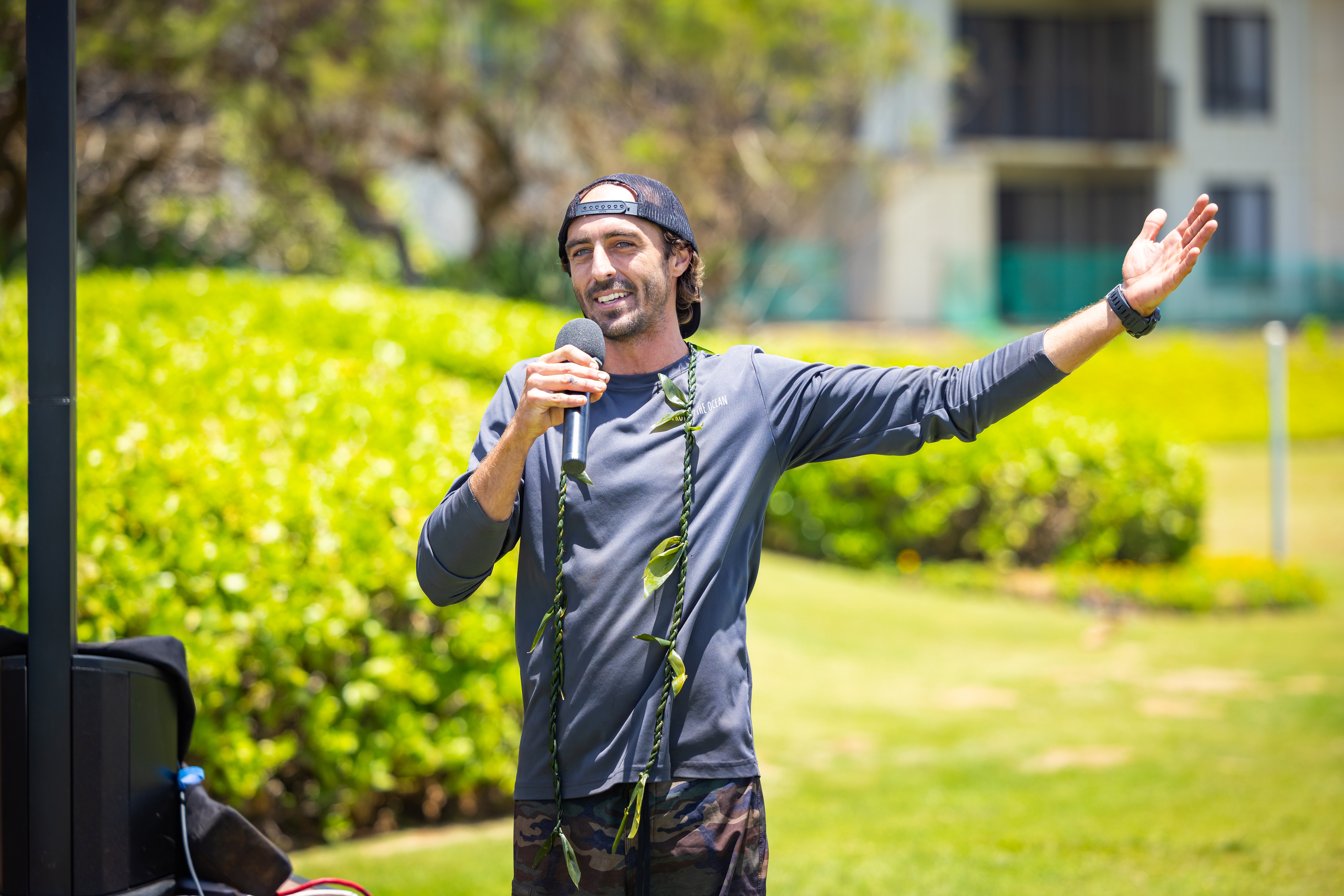 Tim Leichliter Ocean Torchbearer giving a presentation with a microphone on a lawn