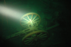 canon underwater illuminated by flashlight