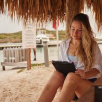 a scuba diving student uses a tablet to study diving theory