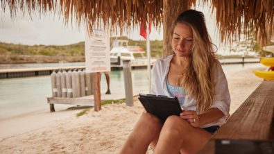 a scuba diving student uses a tablet to study diving theory