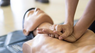 A person practices cpr on a dummy