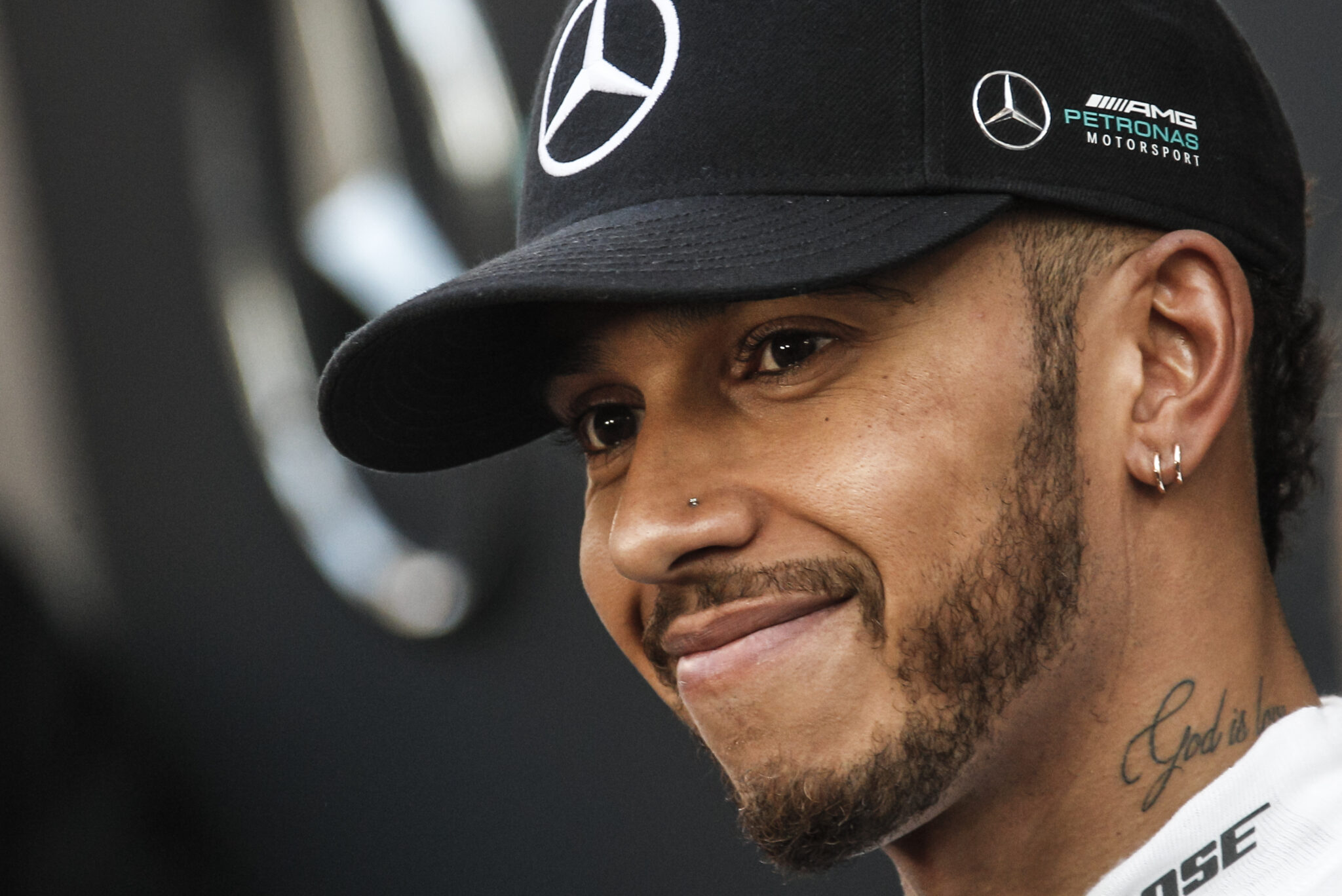 Lewis Hamilton smiles for the camera after a race