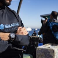 a diver wearing a padi aware rashguard and a seiko watch