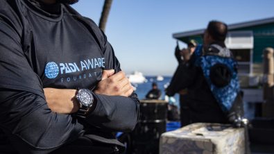 a diver wearing a padi aware rashguard and a seiko watch