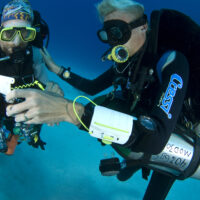 two tec divers communicate underwater
