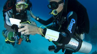 two tec divers communicate underwater
