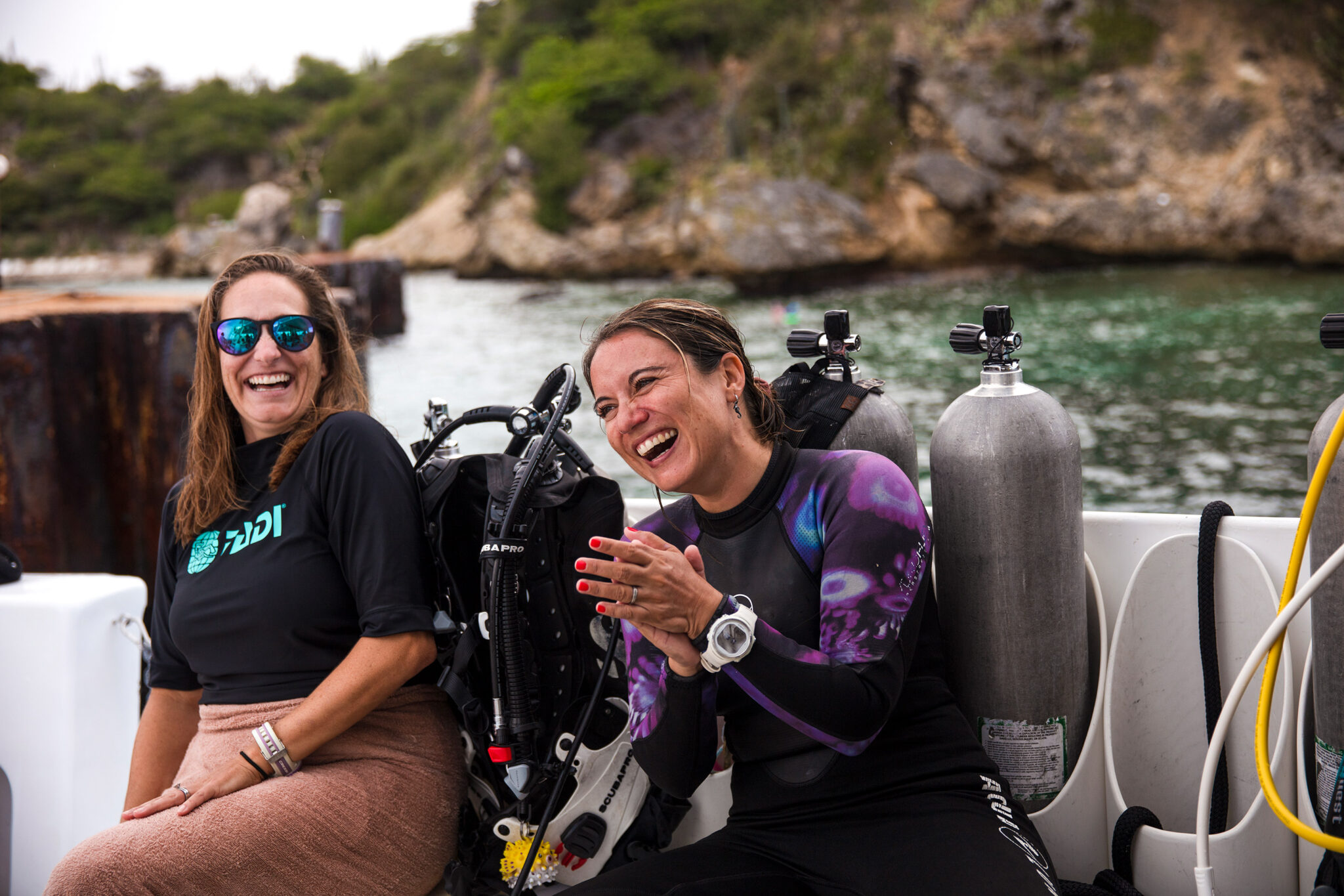 Two divers laughing on the dive boat