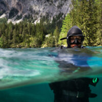 a scuba diver enters a lake in Austria