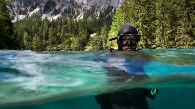 a scuba diver enters a lake in Austria