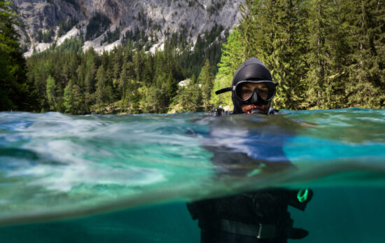 a scuba diver enters a lake in Austria