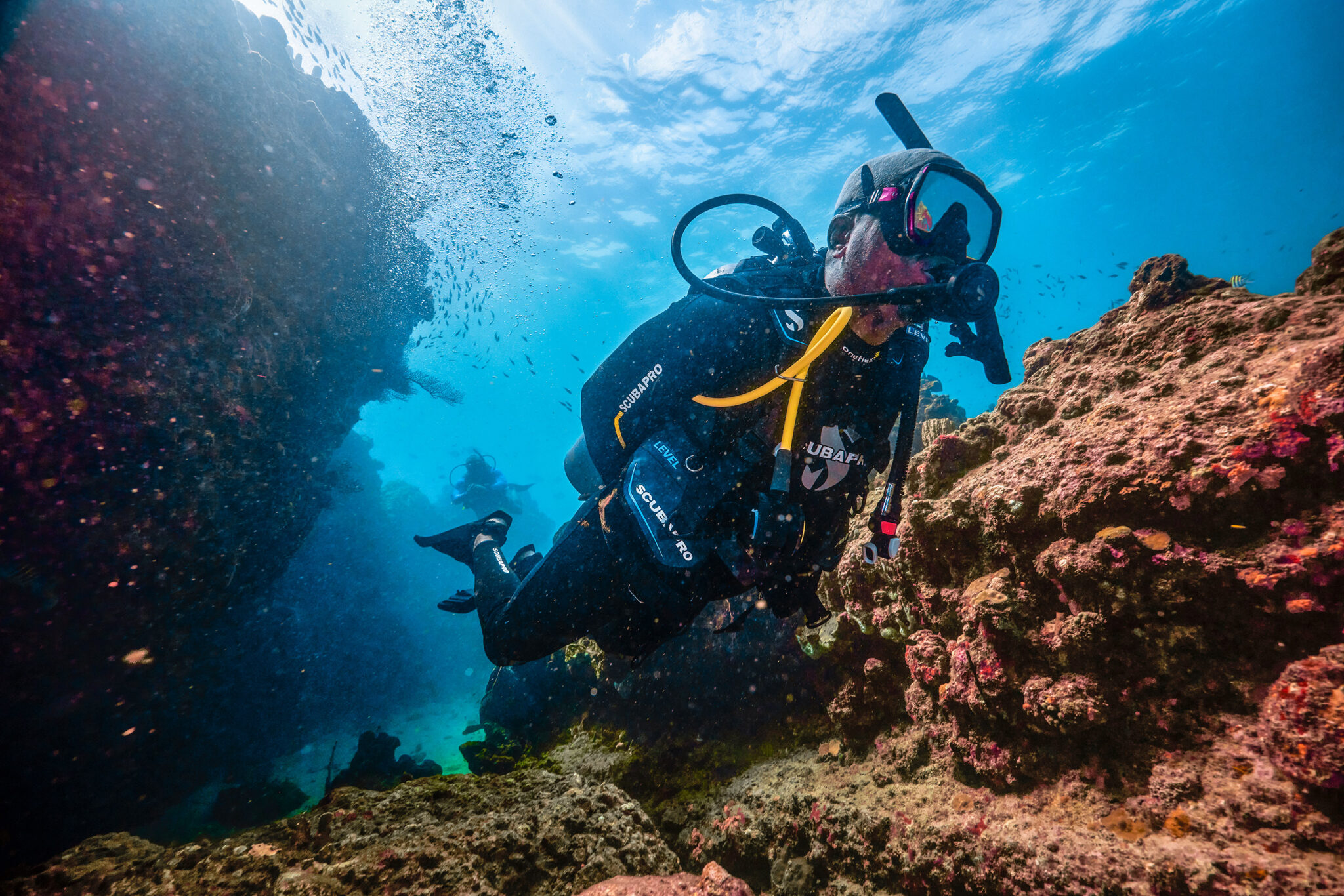 A PADI Instructor swims through a reef in St Lucia