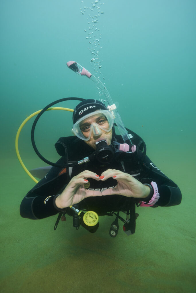 Diver making a heart sign underwater