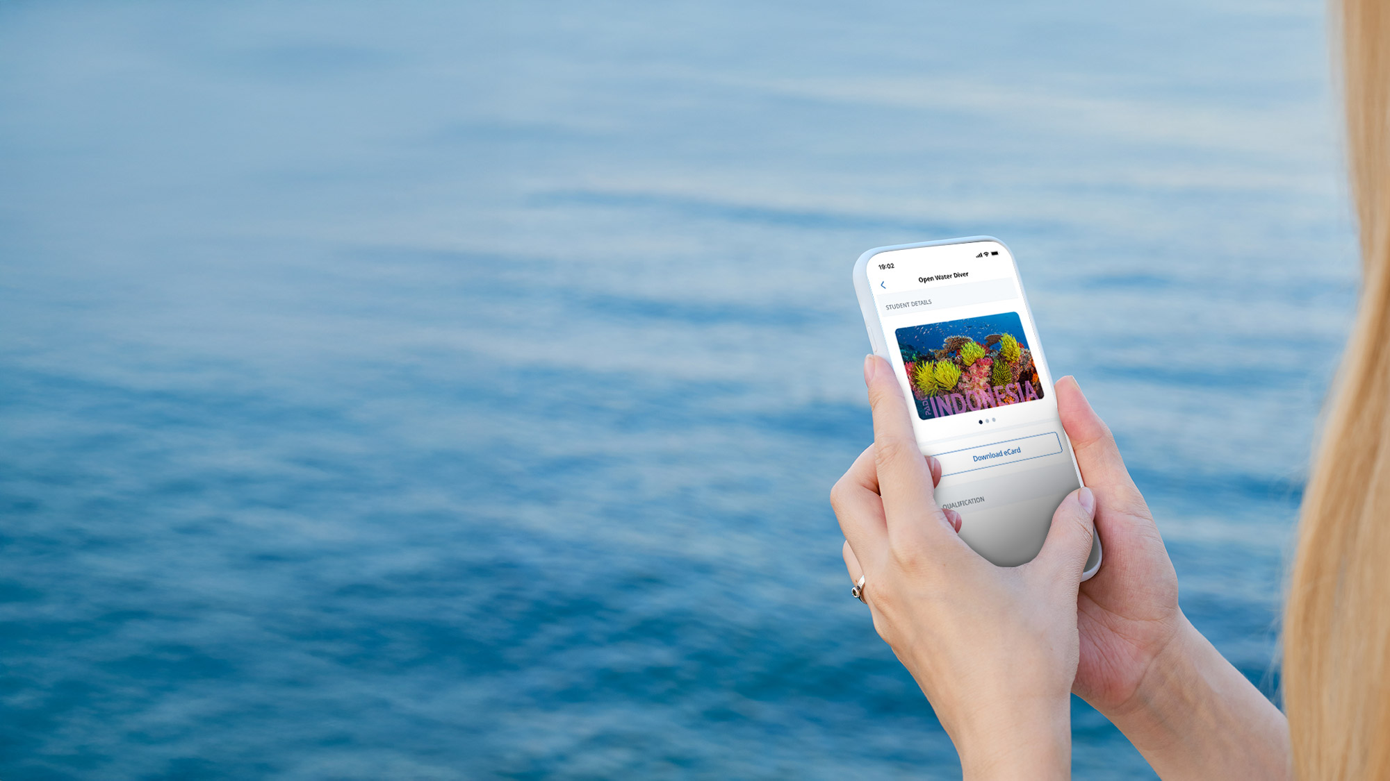 person looking at a cert card on a smartphone
