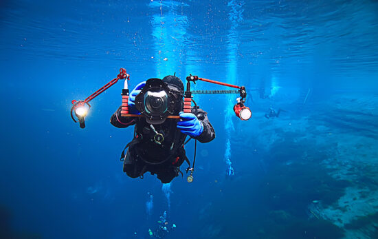 A photographer dives into cold water in Iceland