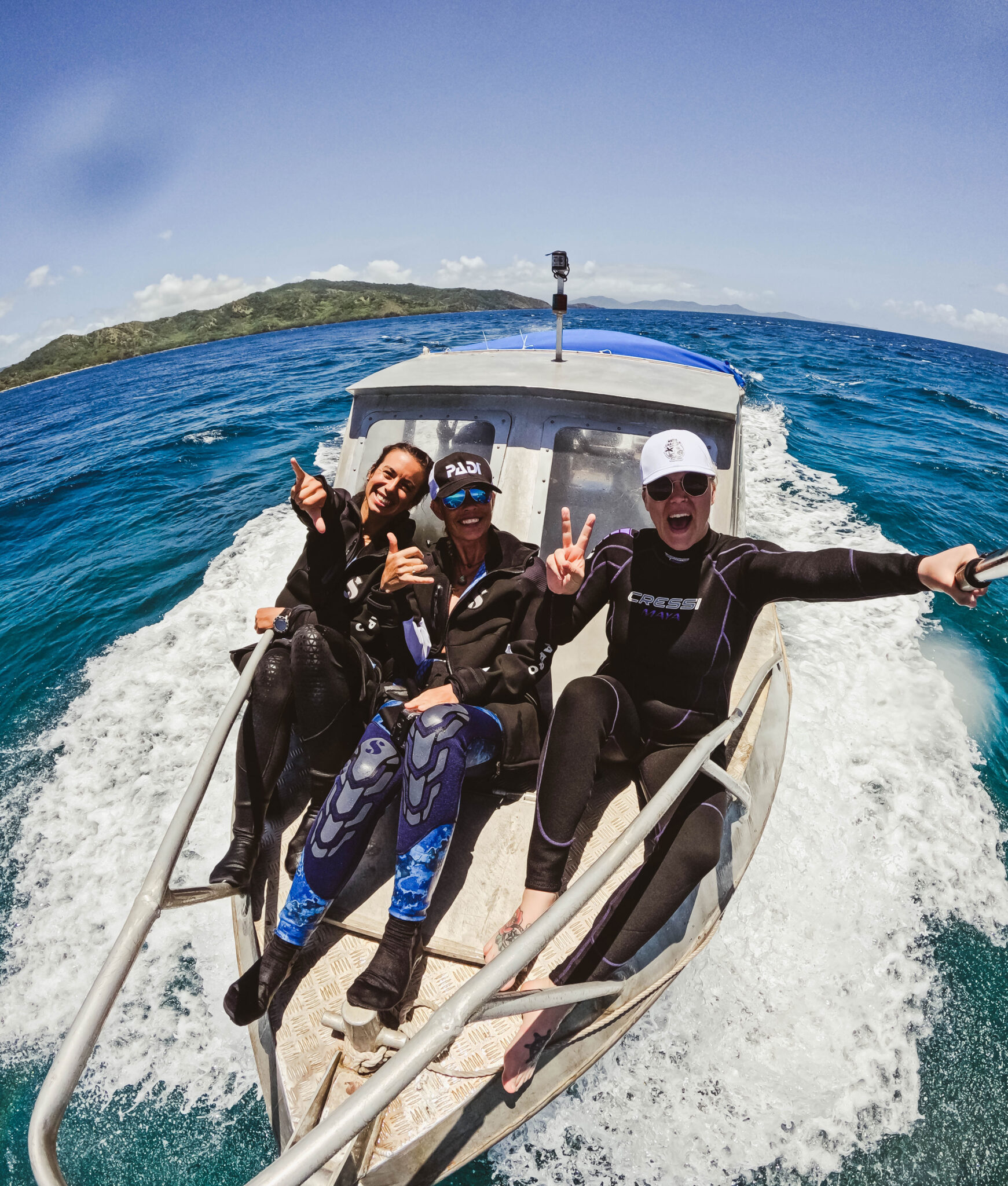 group of divers taking a selfie on a boat