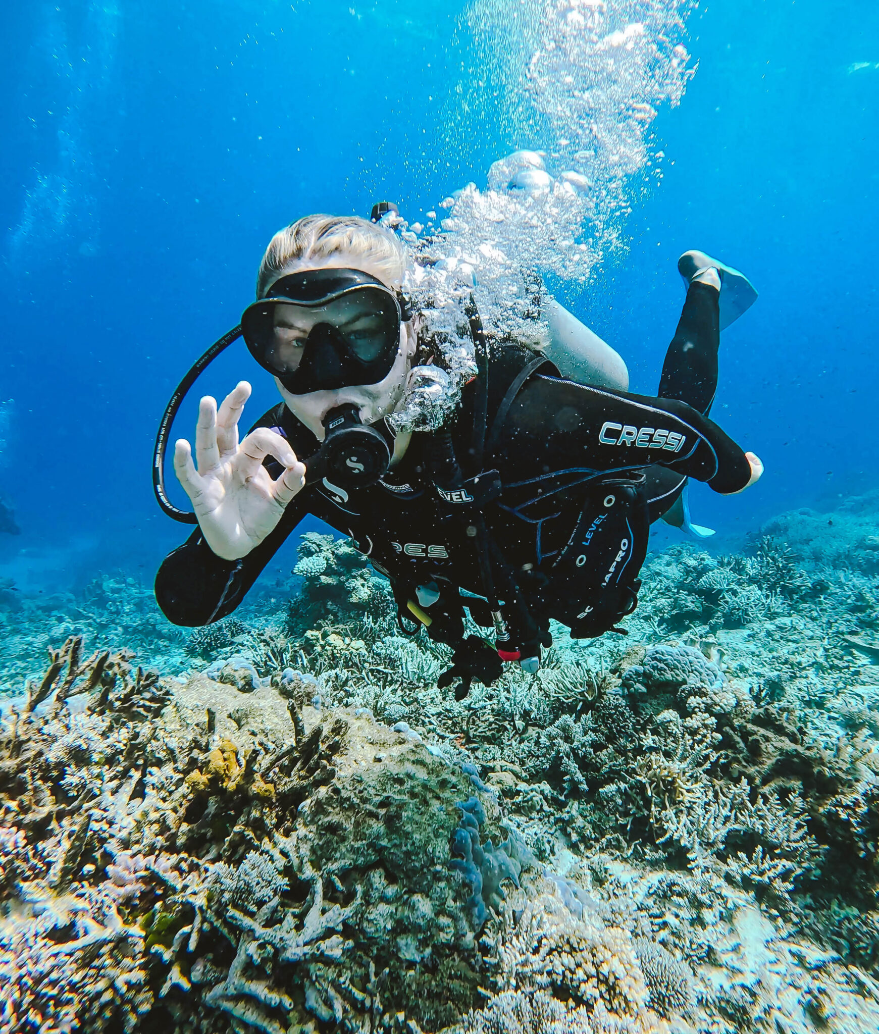 diver looking at the camera and giving the OK sign