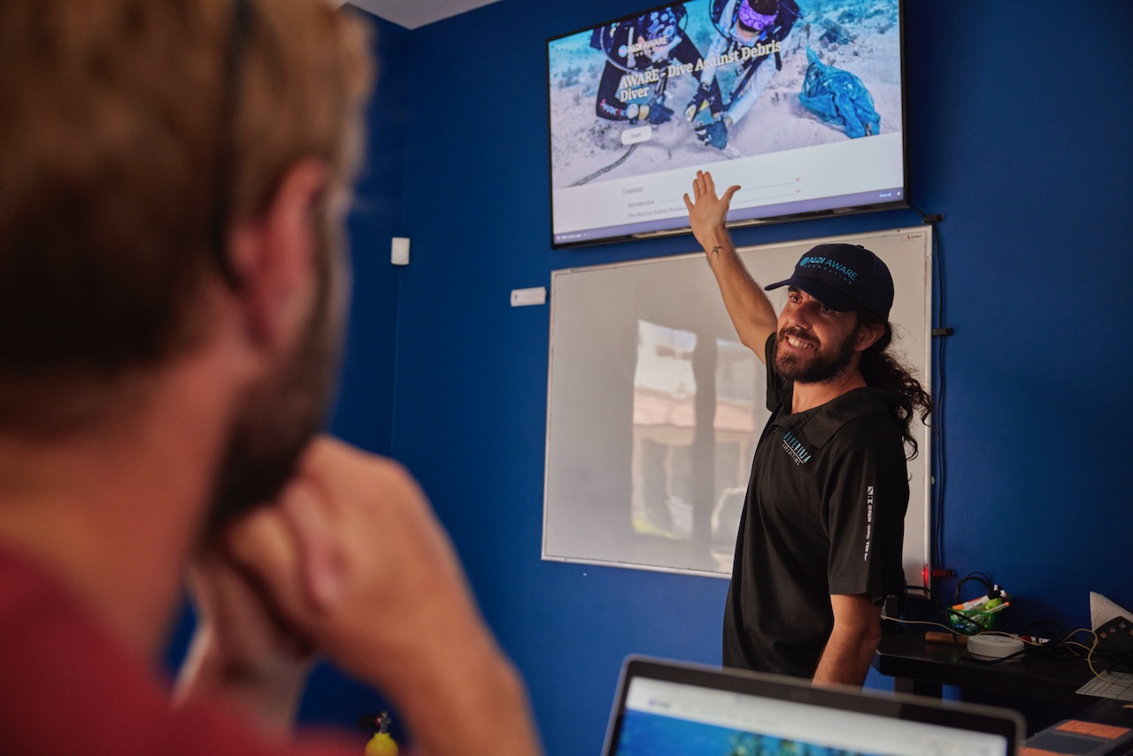 a PADI Instructor gives a presentation about the PADI AWARE Foundation