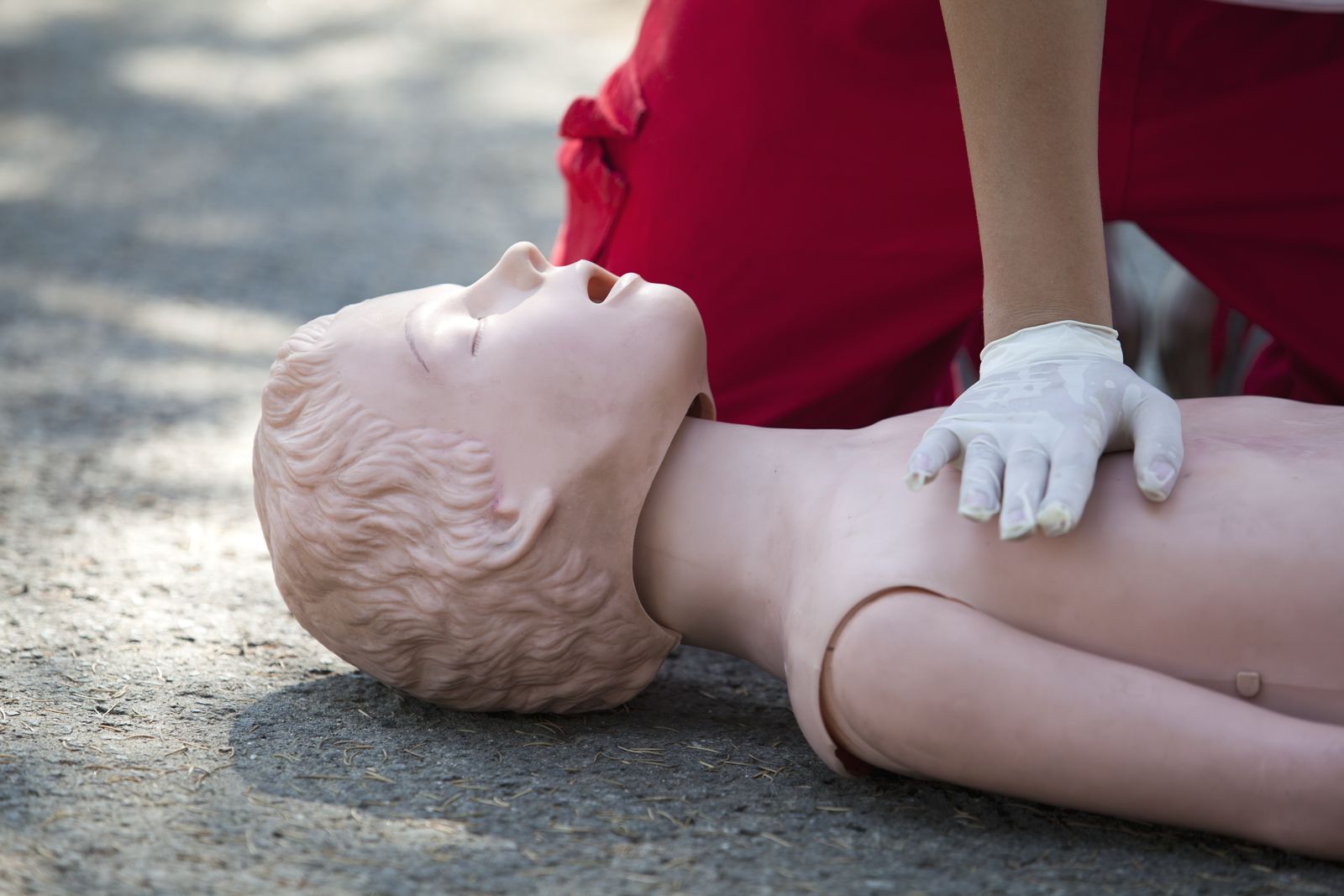 someone performing cpr on a child dummy shutterstock
