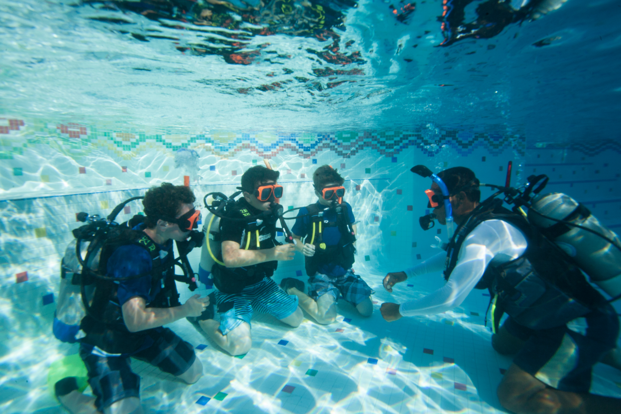 Group of kids learning to scuba dive