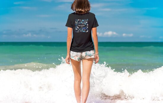 a lady on the beach wearing PADI T shirt