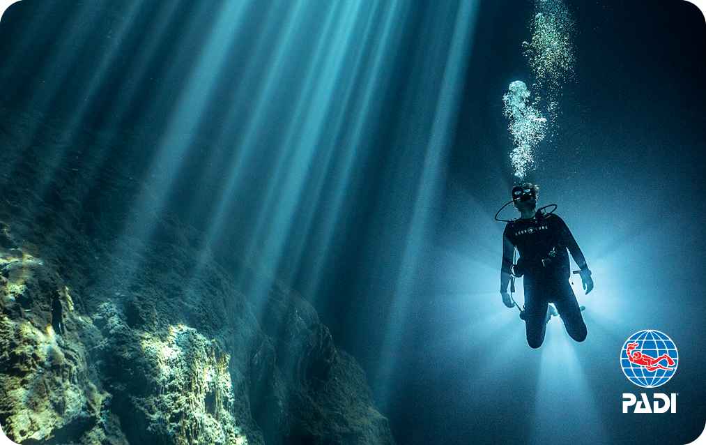 a scuba diver exploring the cenotes