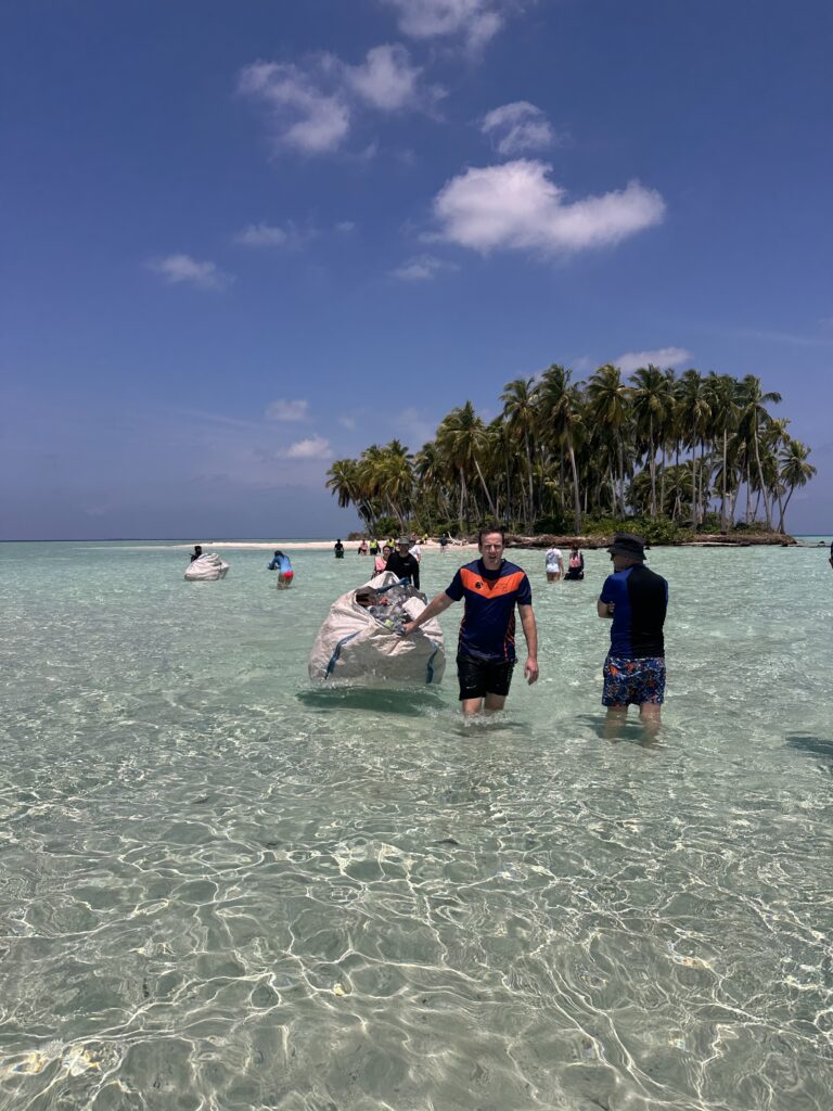 volunteers moving collected rubbish from a deserted island 