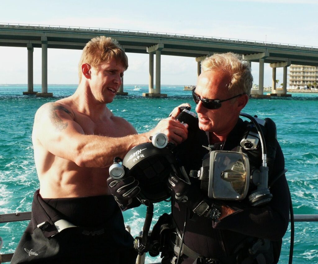 A divemaster checks Michael Gray's dive kit.