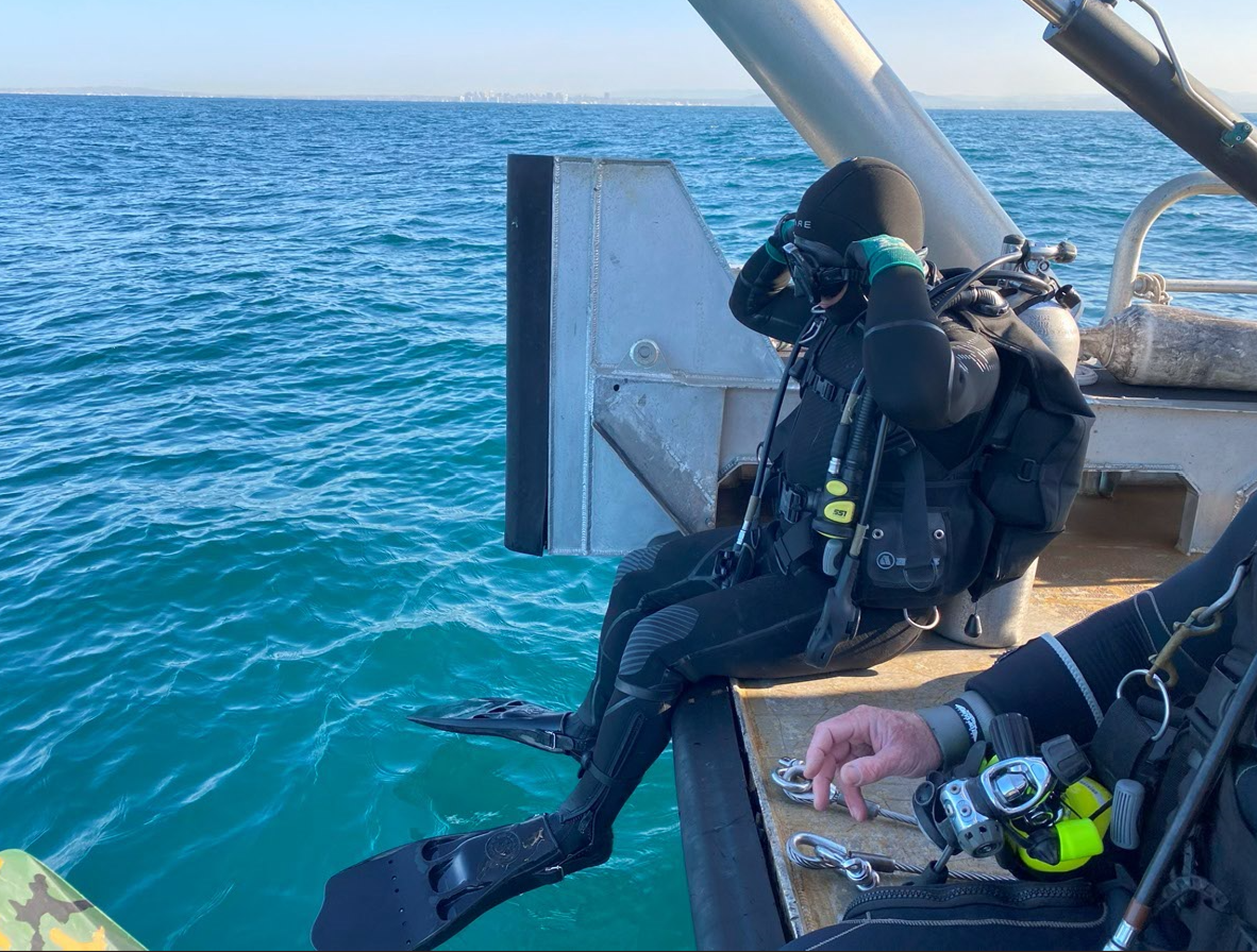Military diving specialist getting ready to hop in the water.