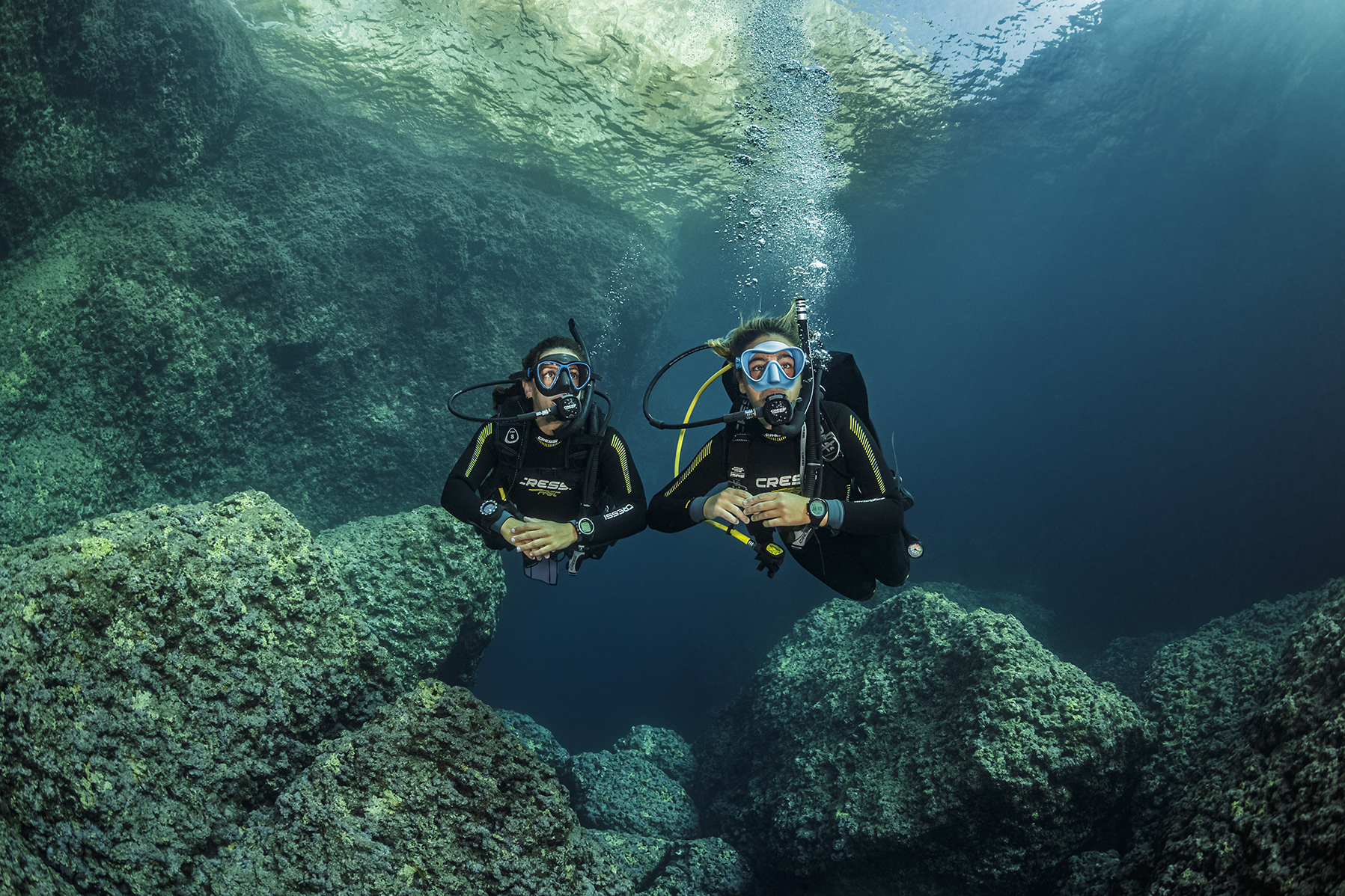 two divers explore the underwater world in Greece