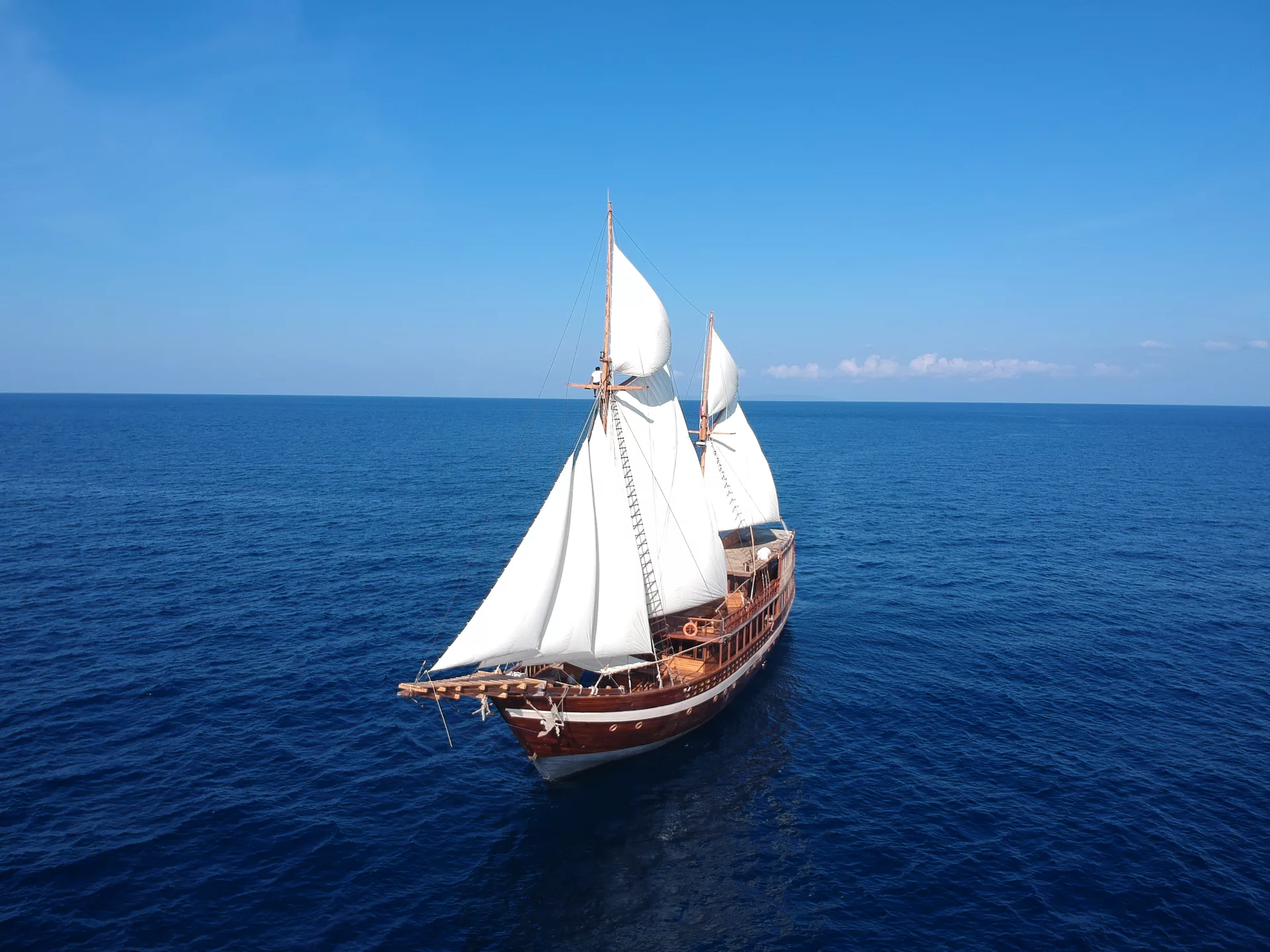 A liveaboard with white sails in Indonesia