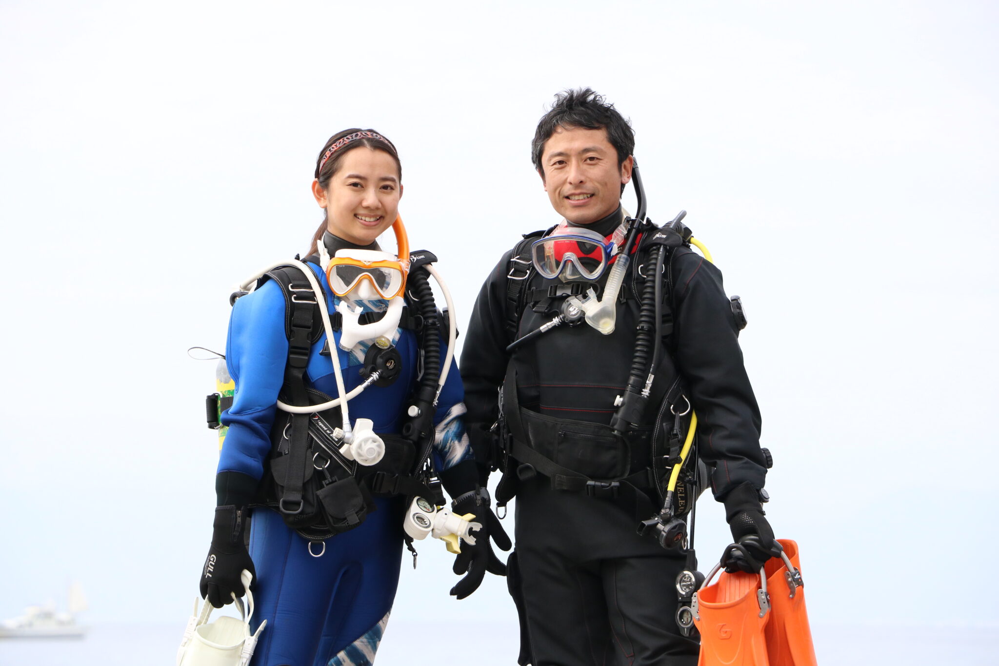 two diver wearing dry suit are ready to dive