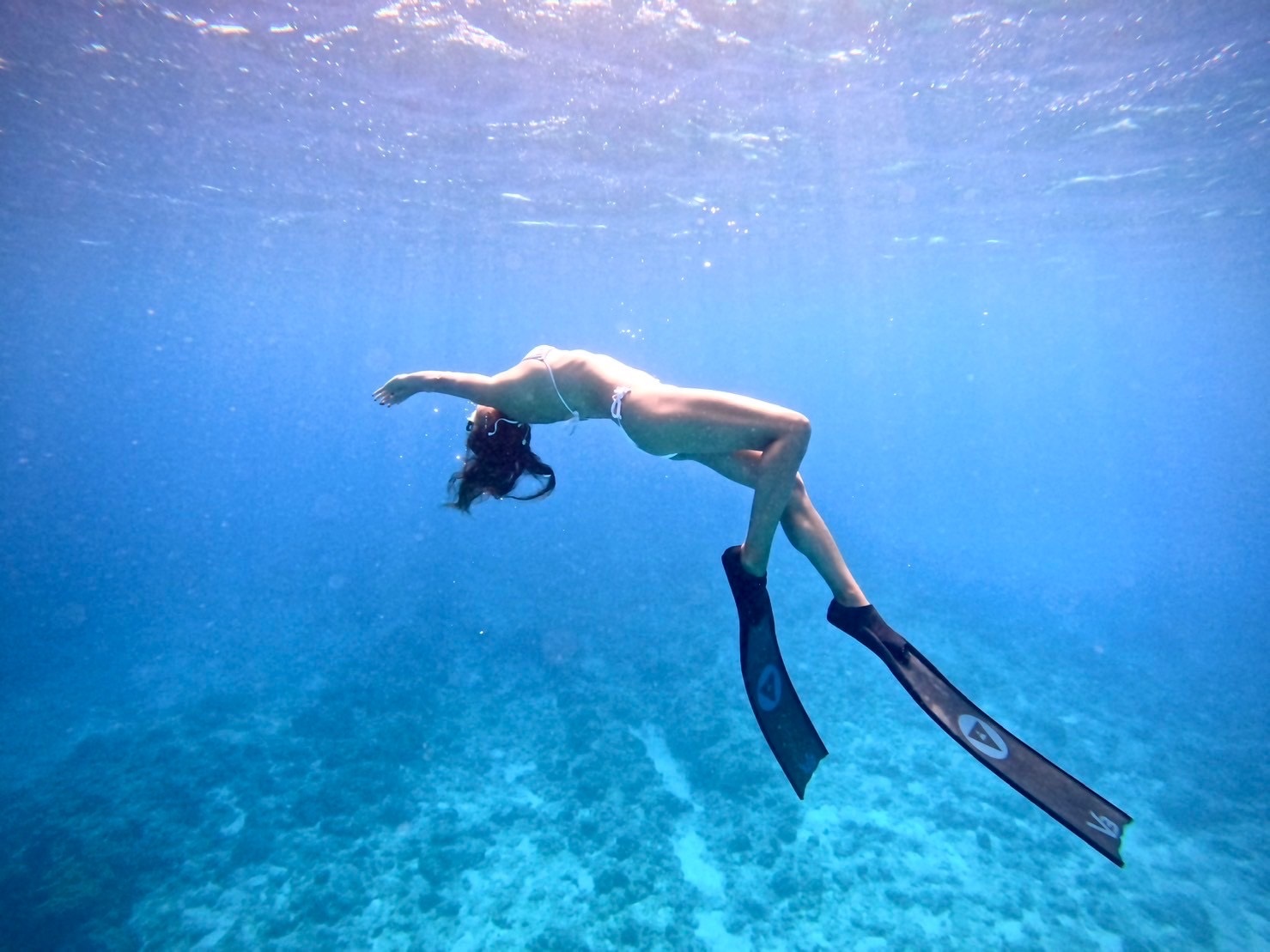 A female freediver swimming in the ocean