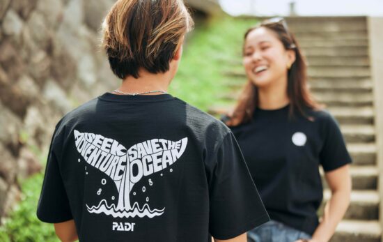 two models wearing a PADI fin design t shirt