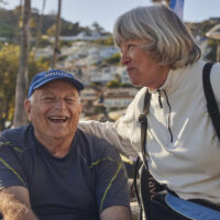 Elderly man and woman talking and smiling