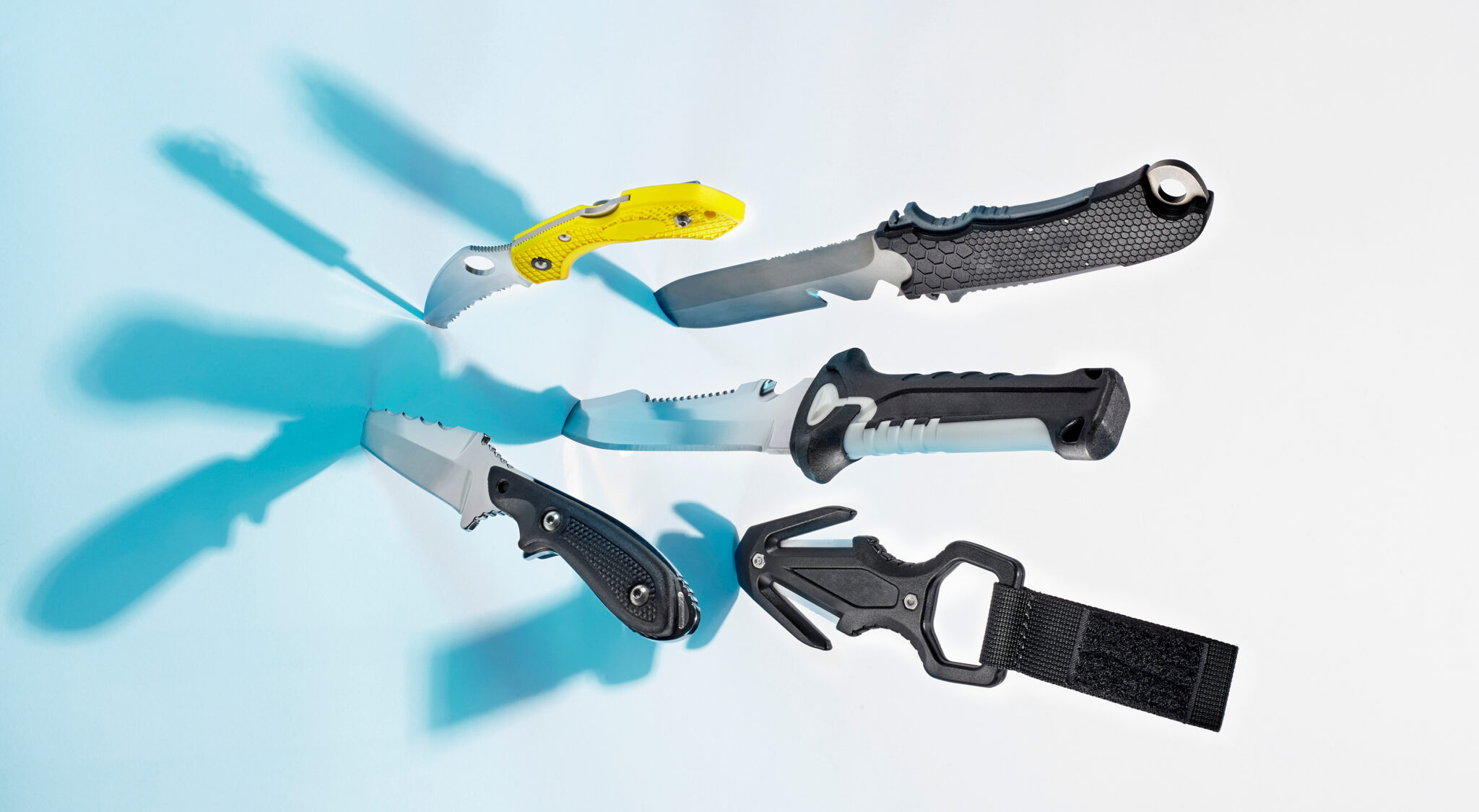 A dive knife comparison that shows different types of cutting tools including line cutters, folding blades, and fixed blades