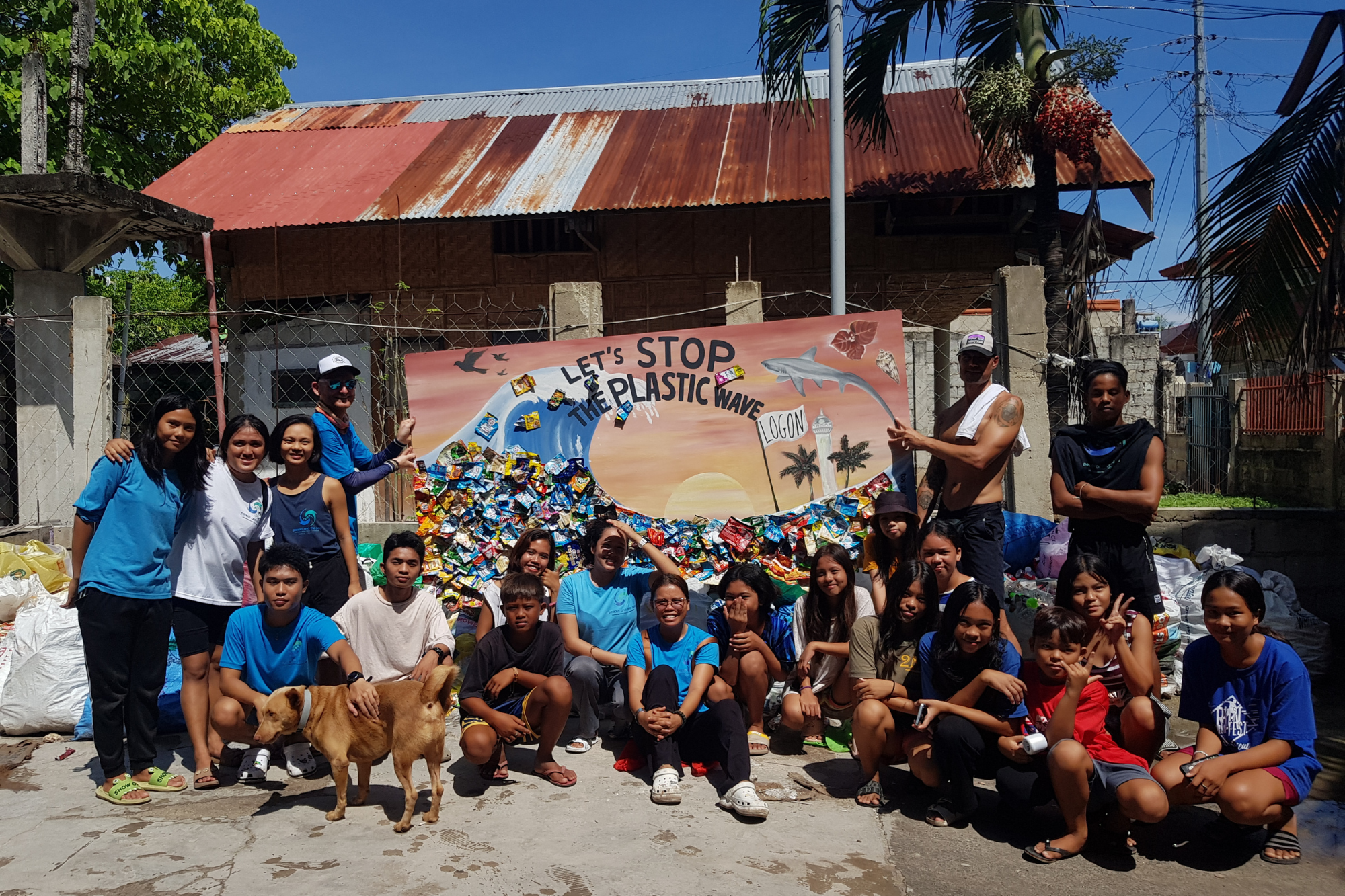 People and the Sea group picture in front of conservation sign