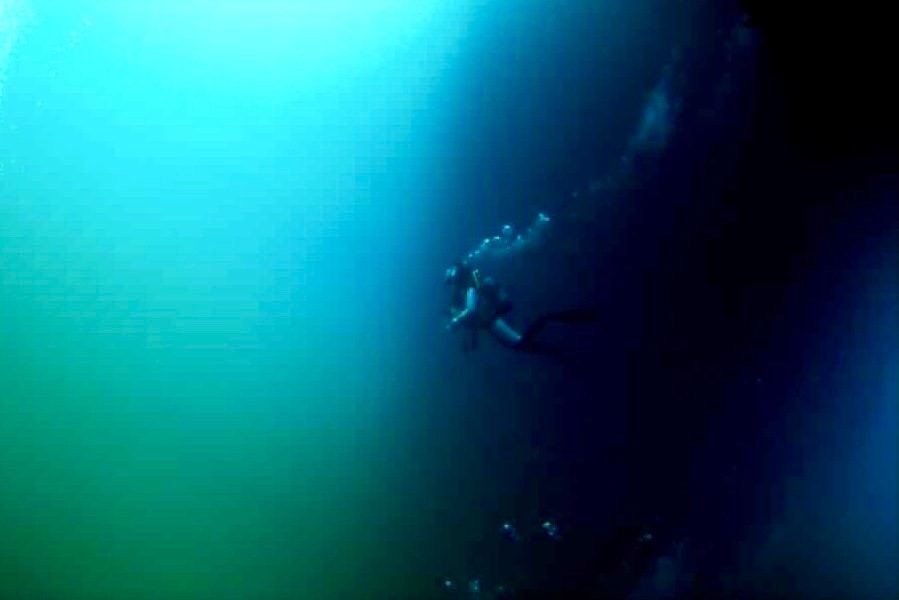 a diver going into the Toriike in Miyakojima Japan seeing chemocline